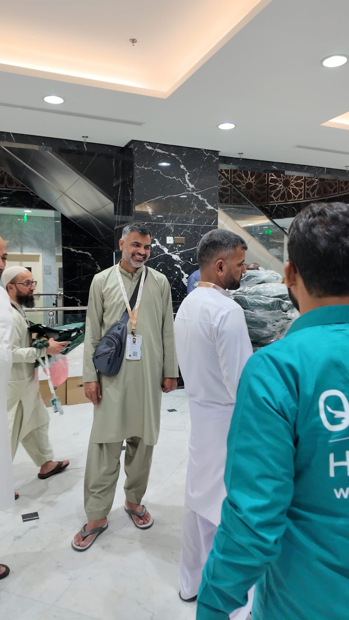 AlFursan team with pilgrims in the hotel lobby