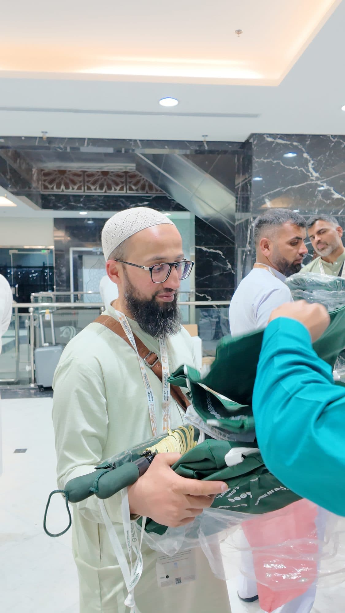 AlFursan team welcoming pilgrims and handing out Hajj kits